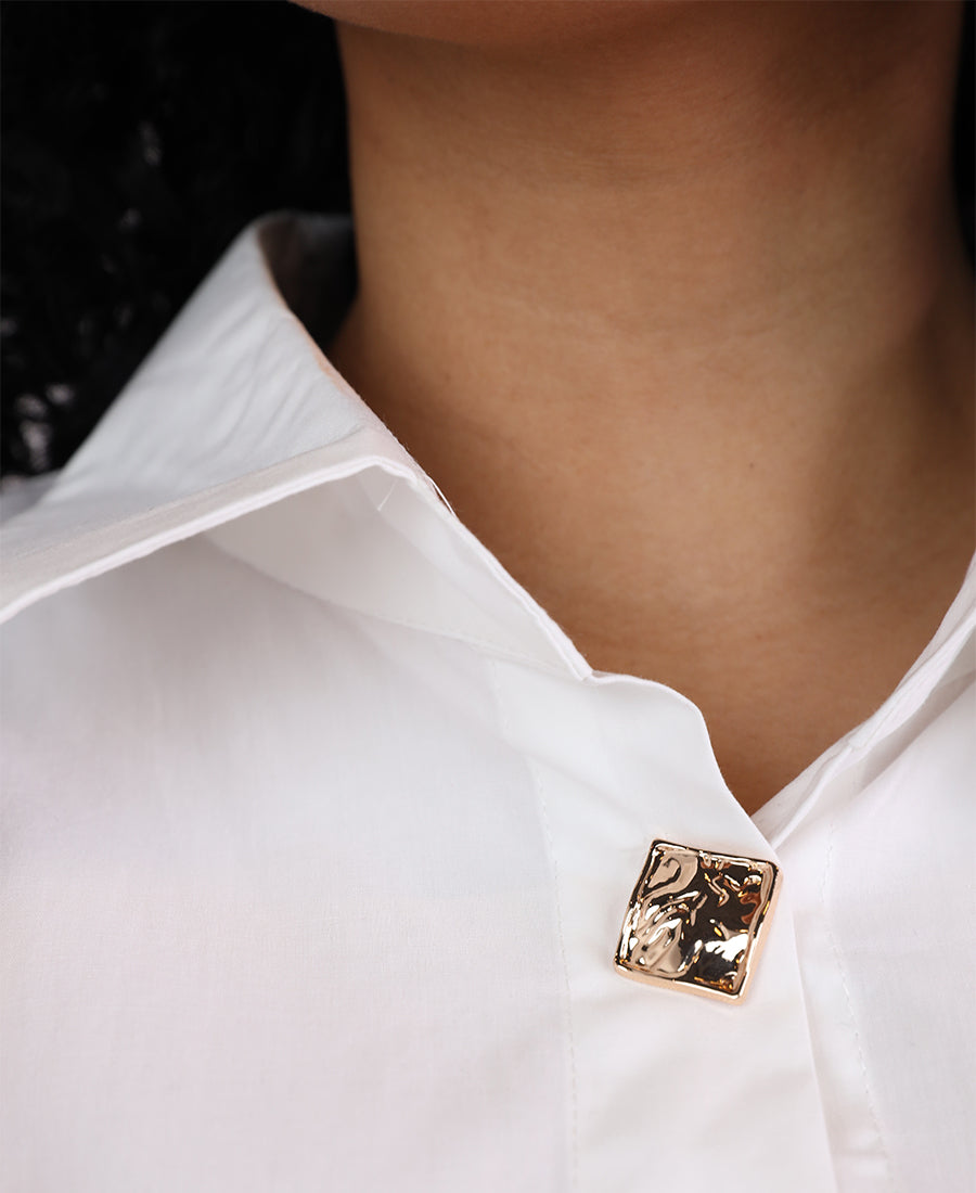 Shirt with assorted buttons and gold trim