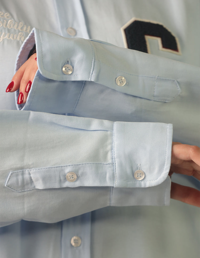 Oversized light blue shirt with the word "C" printed on it