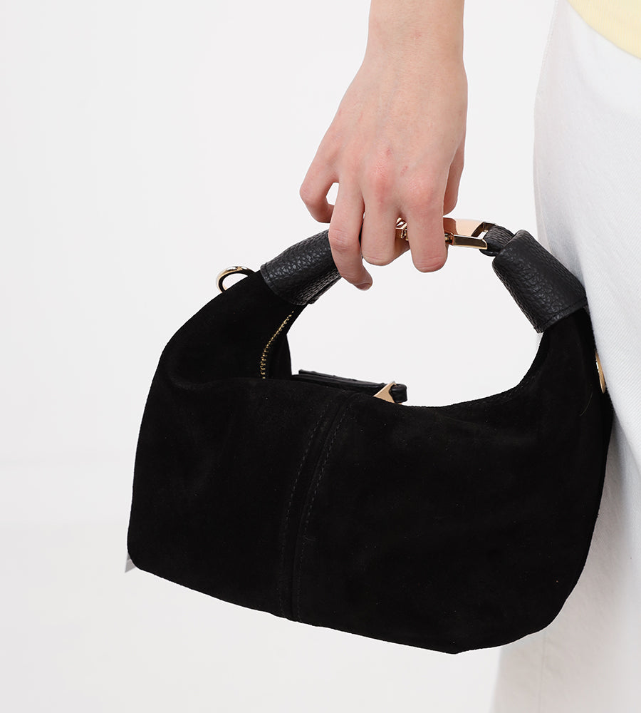Small suede handbag with a gold buckle