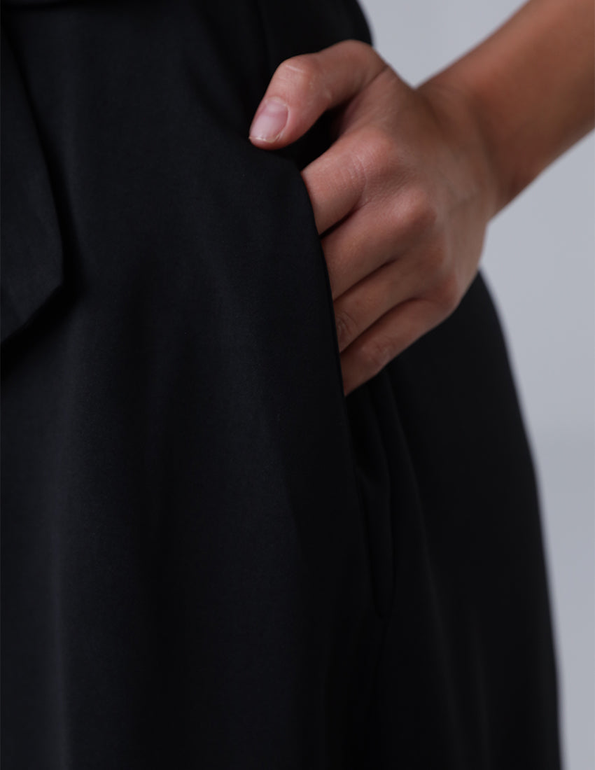 Black wide leg jumpsuit, sleeveless, with a waist tie.