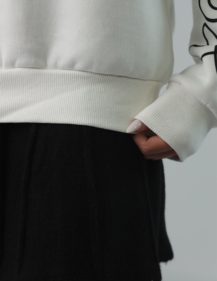 Oversized white blouse with a design on the sleeves