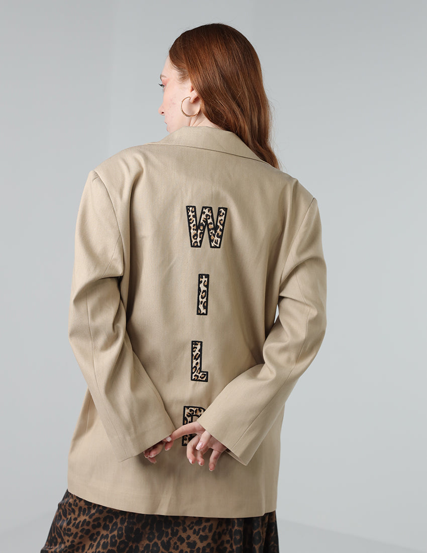 Beige oversized blazer with "WILD"