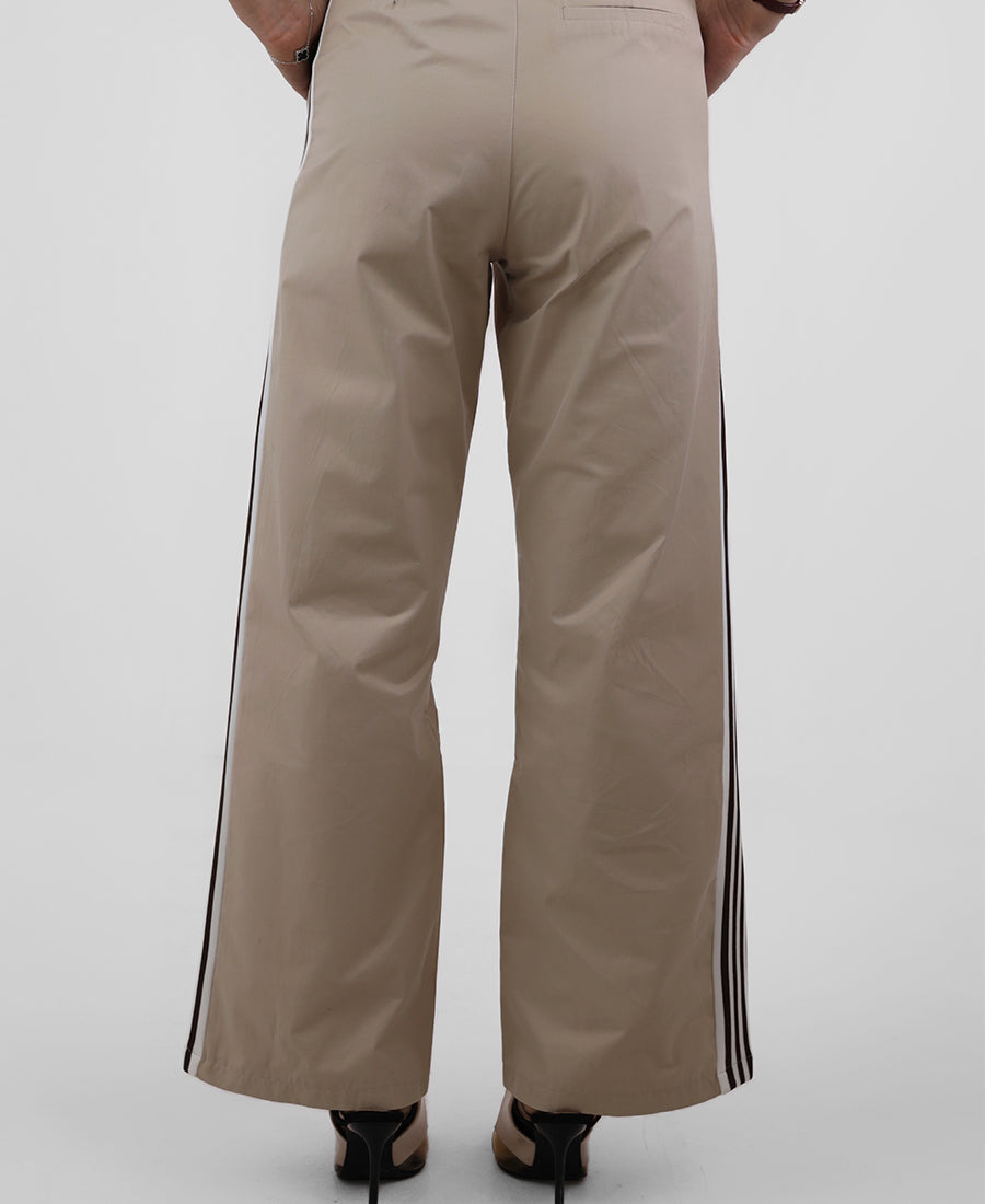 Beige trousers with black stripes on the sides