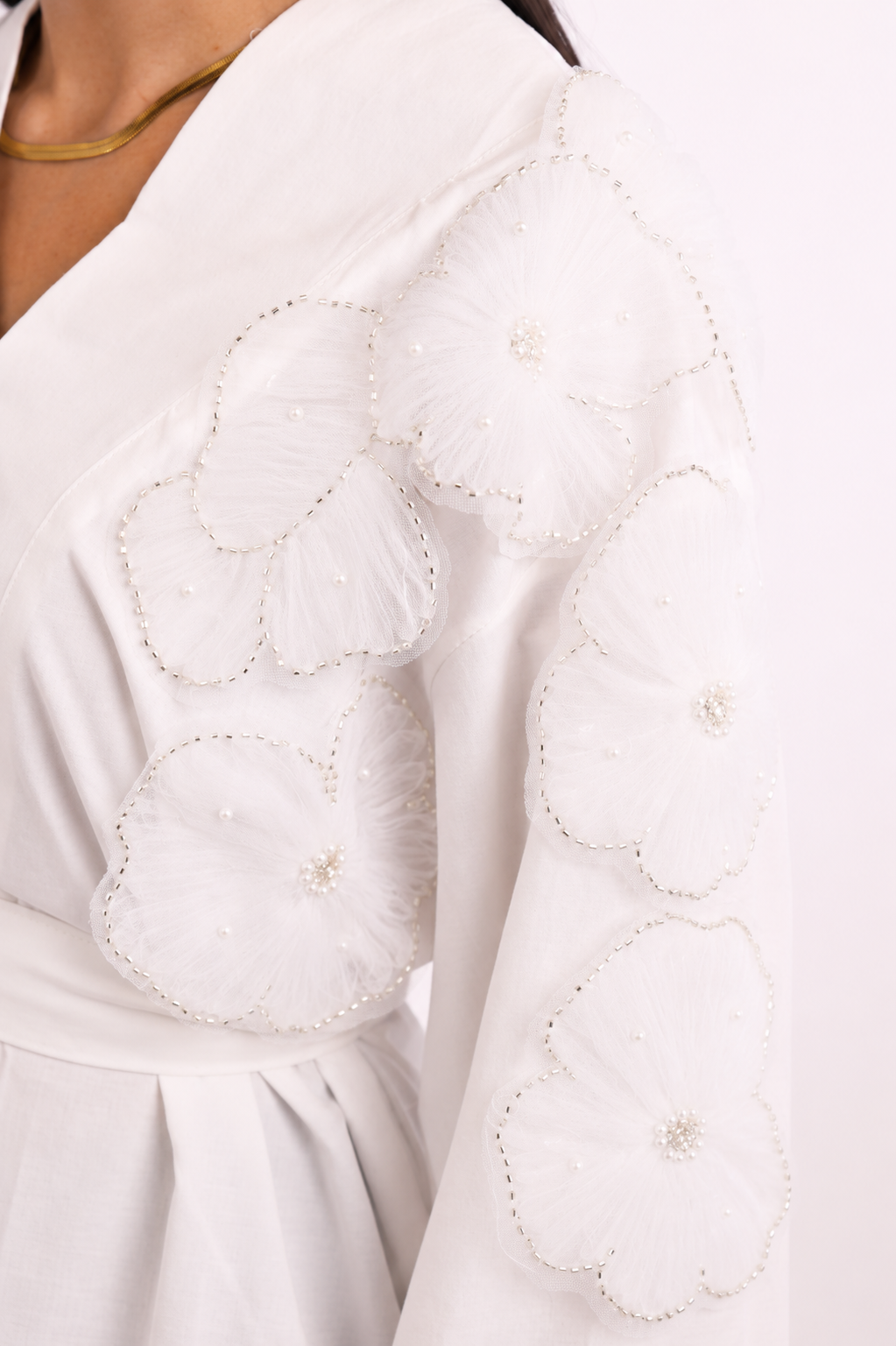 V-neck blouse adorned with shimmering roses, tie waist