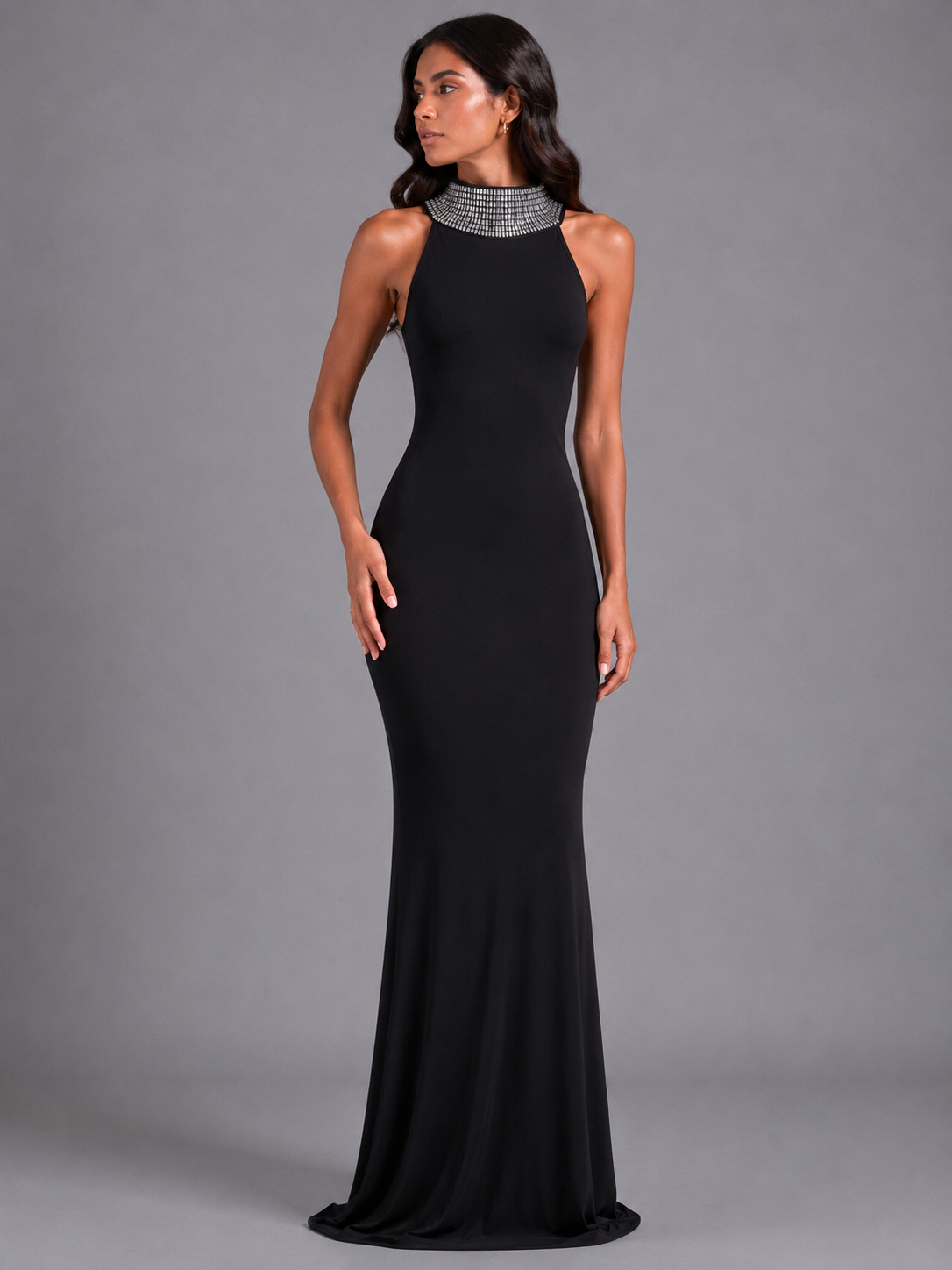 Long black halter-neck dress with rhinestones at the neckline.