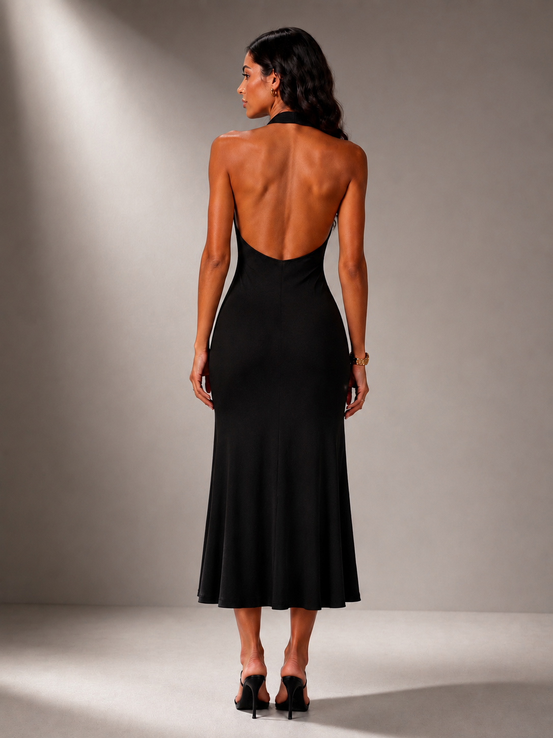Black long halter-neck skater dress with an open neckline.