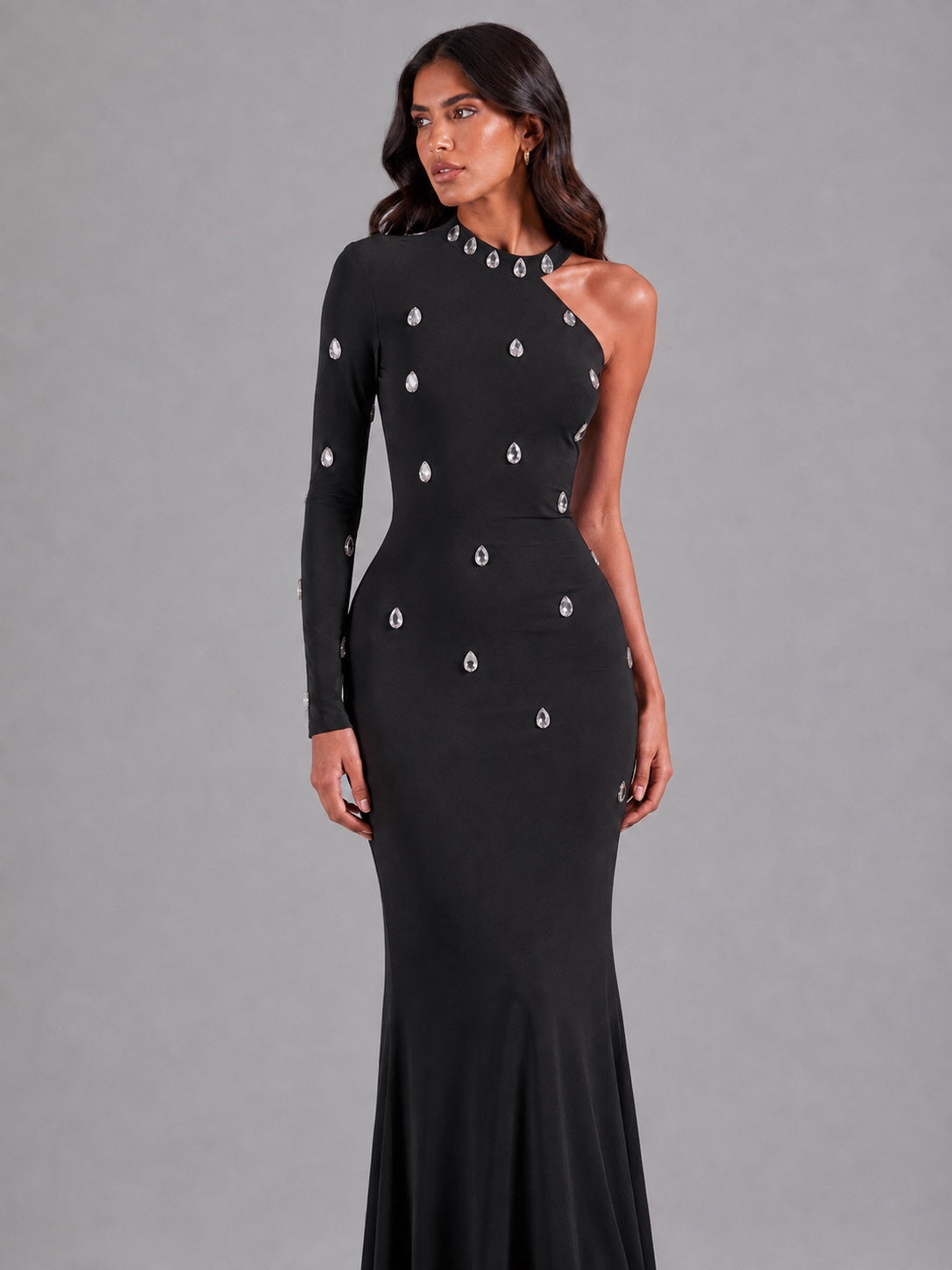 Long black one-shoulder dress with crystals.