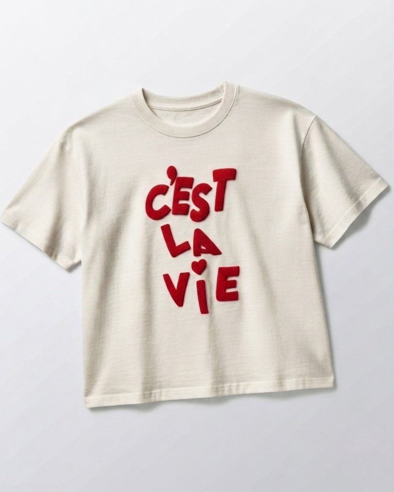 Oversized white T-shirt with "C'est la vie" written in red.