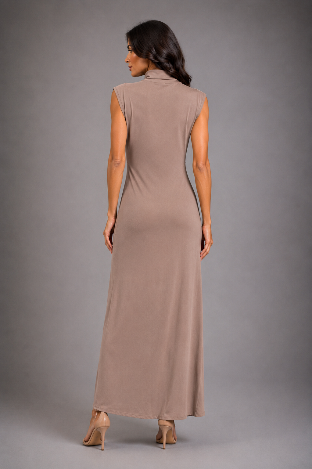 High-neck sleeveless dress featuring waist ruffles and a slit.