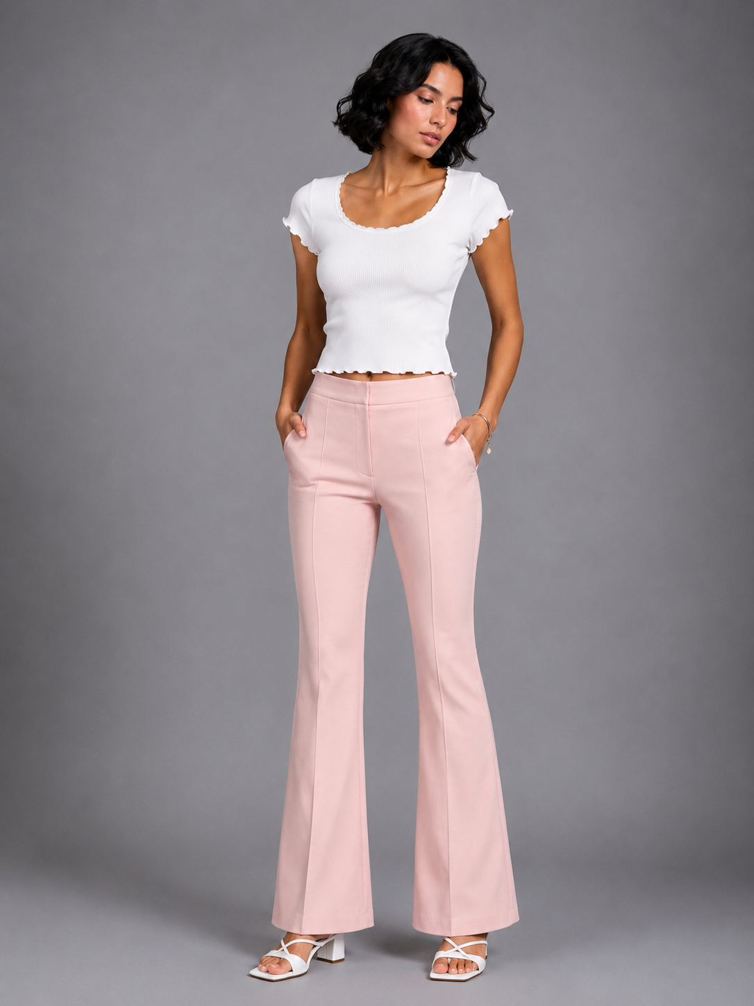 Pink flared trousers with a center crease.