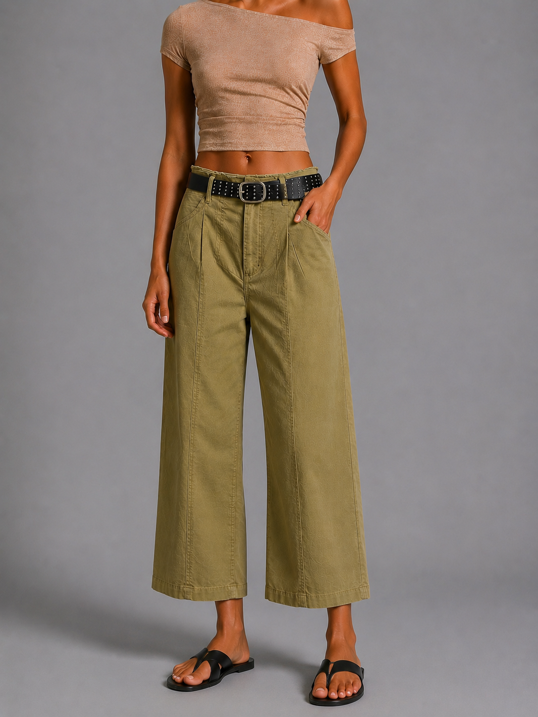 Olive green straight-cut trousers with a black belt.