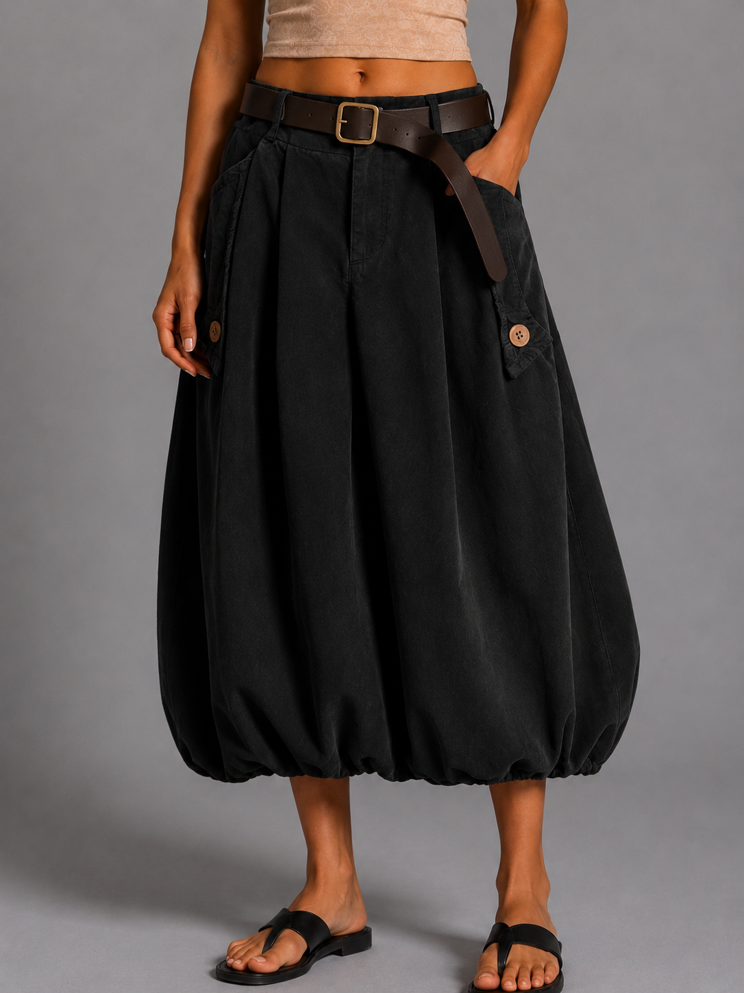 Long black corduroy skirt with a brown belt.