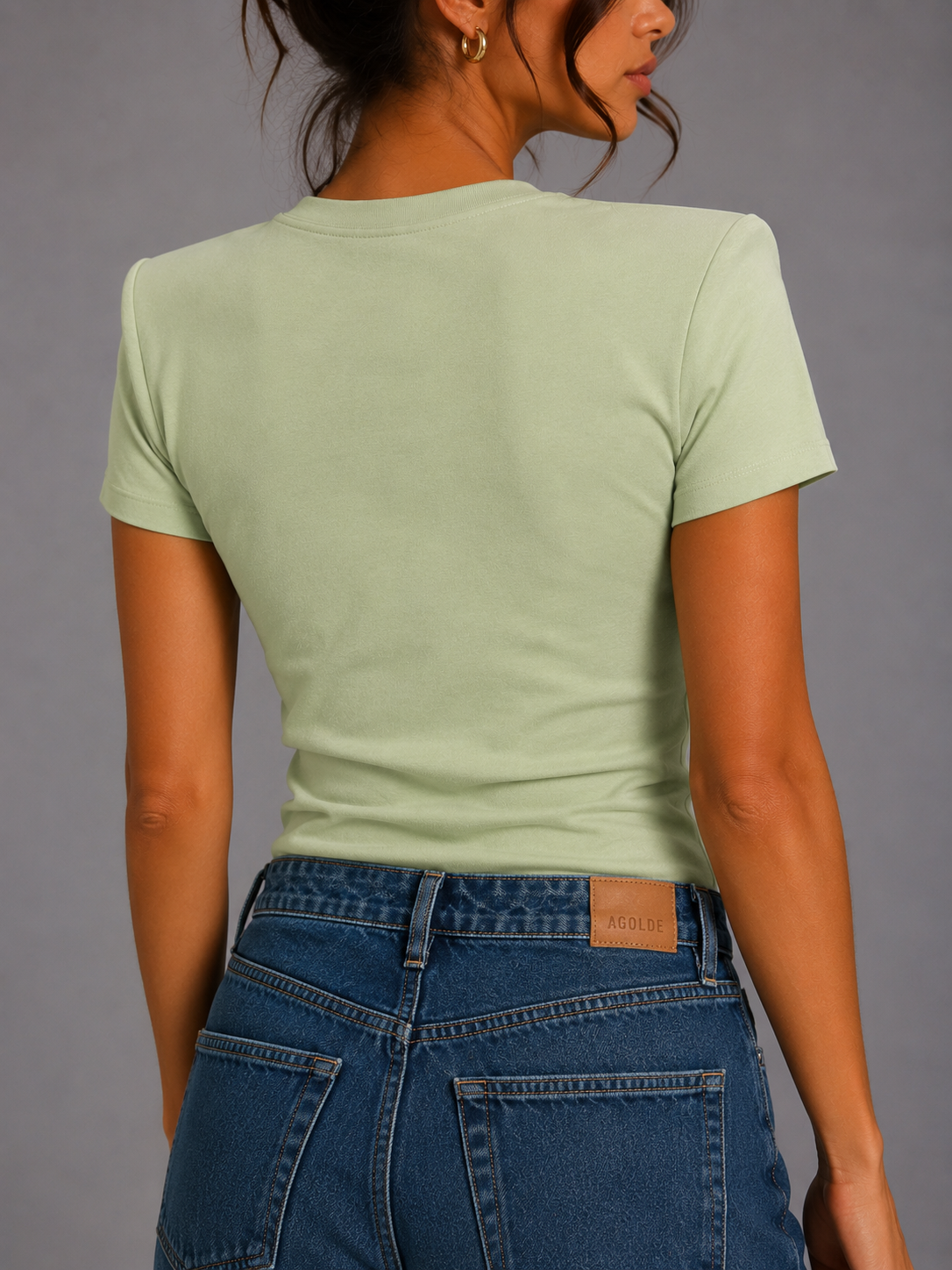 Pistachio-colored T-shirt with shoulder pads.