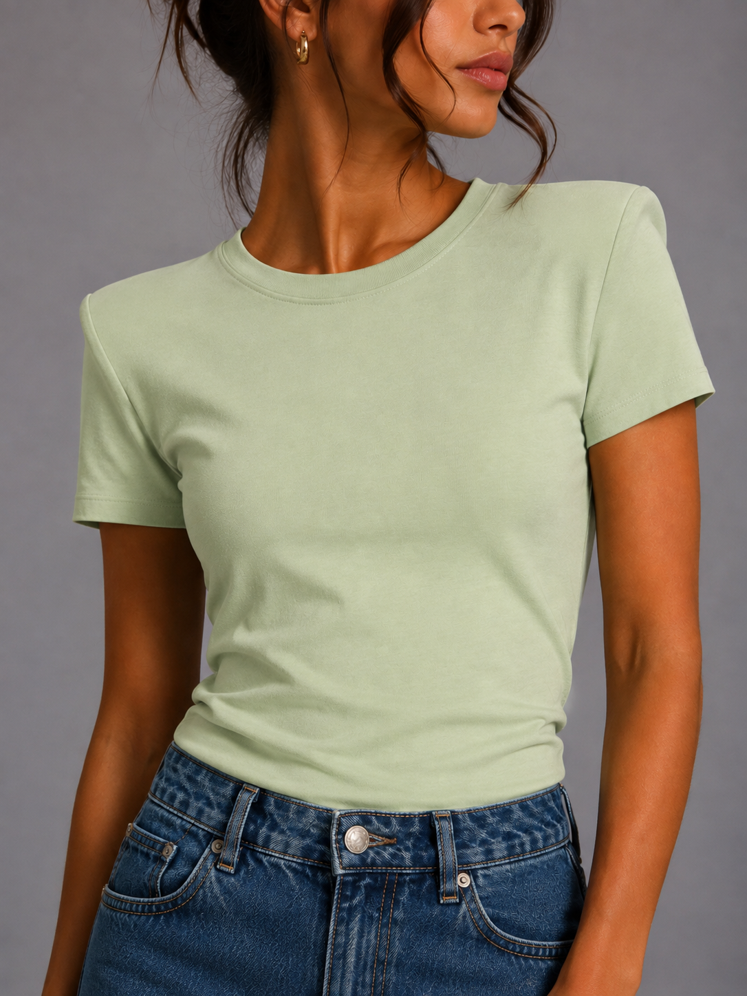 Pistachio-colored T-shirt with shoulder pads.