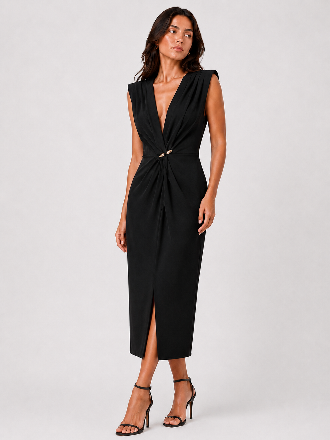 Long black V-neck dress with a gold brooch.