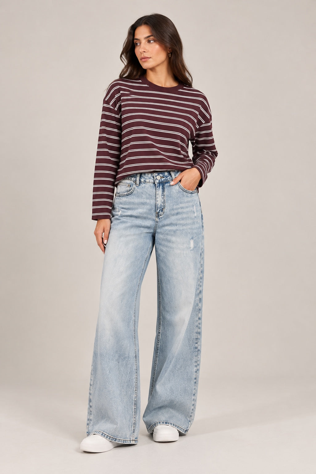 Ice-wash straight-leg jeans with front distressing.