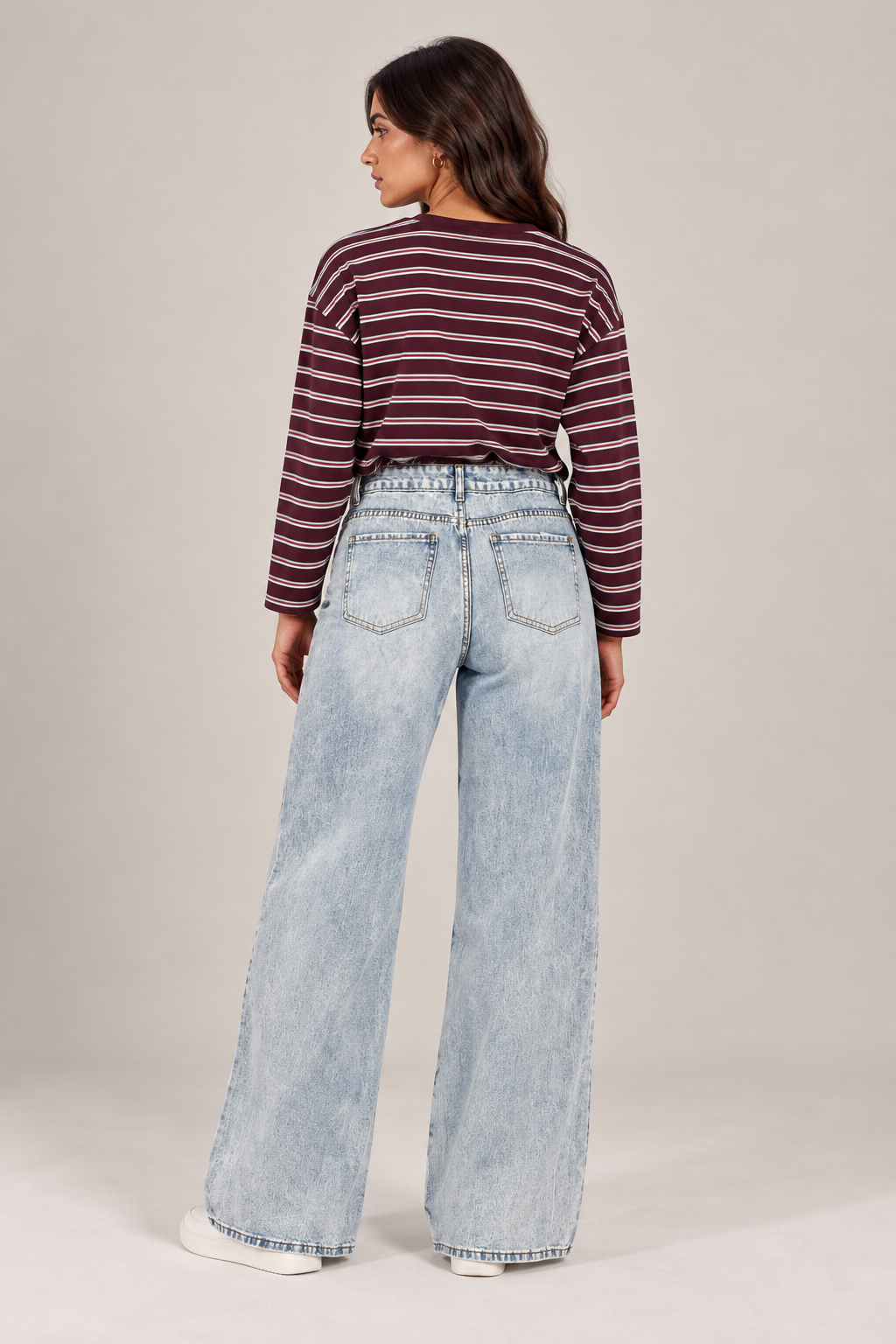 Ice-wash straight-leg jeans with front distressing.