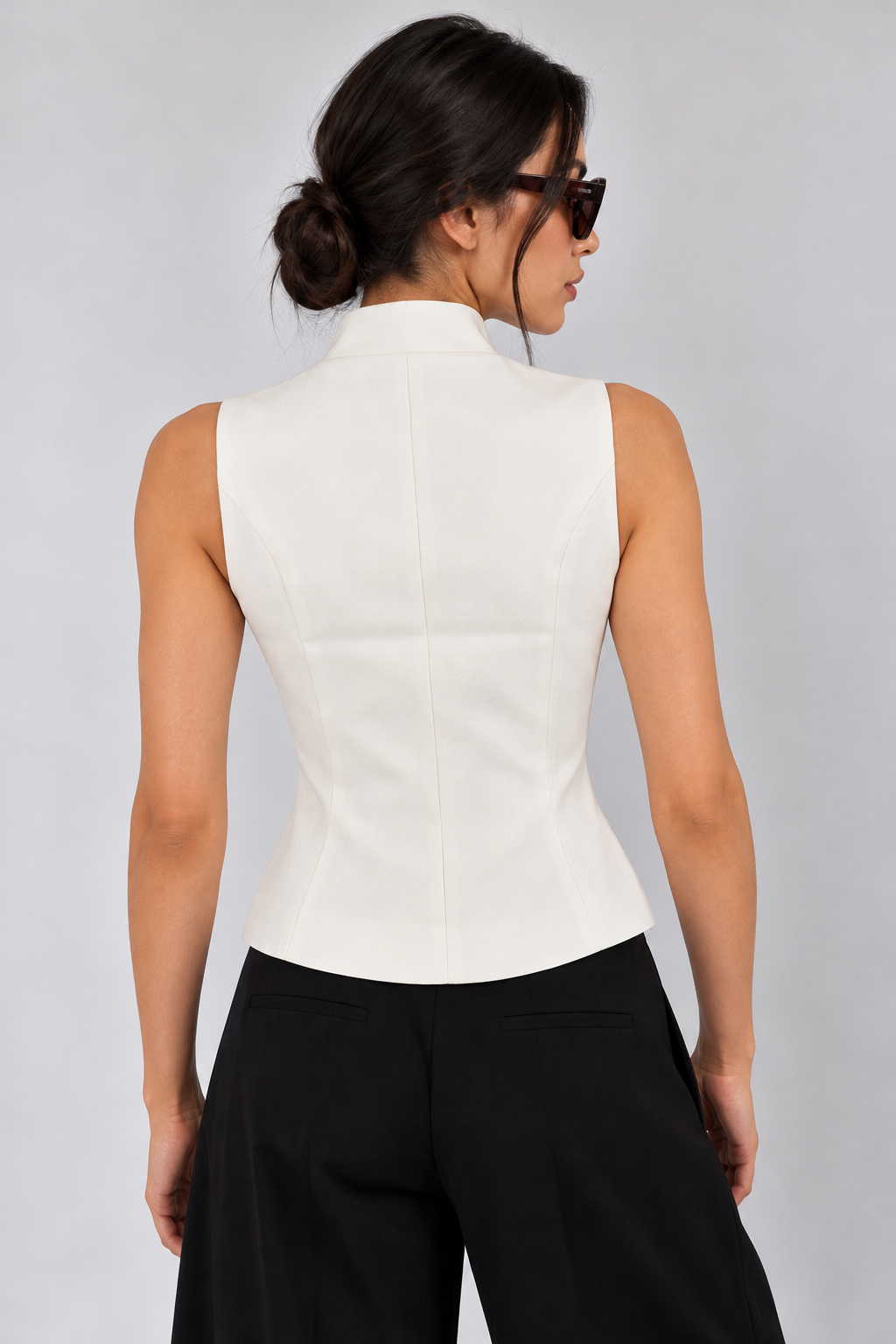 Military-style vest with bronze-colored buttons
