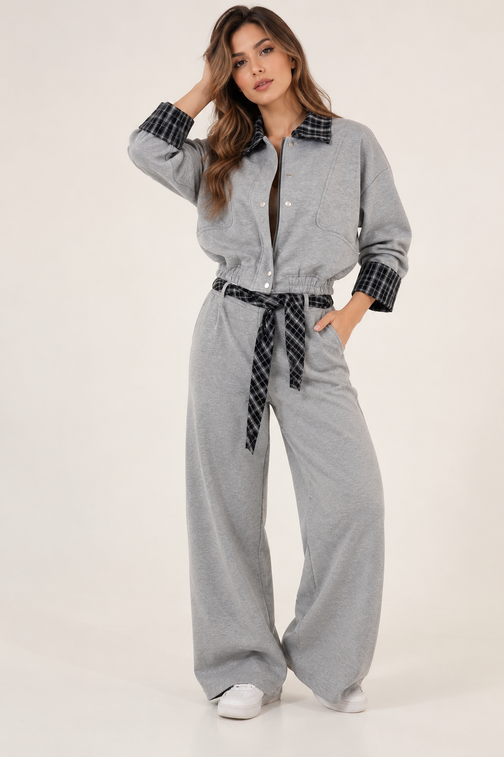 Gray straight-cut trousers with a black plaid scarf at the waist