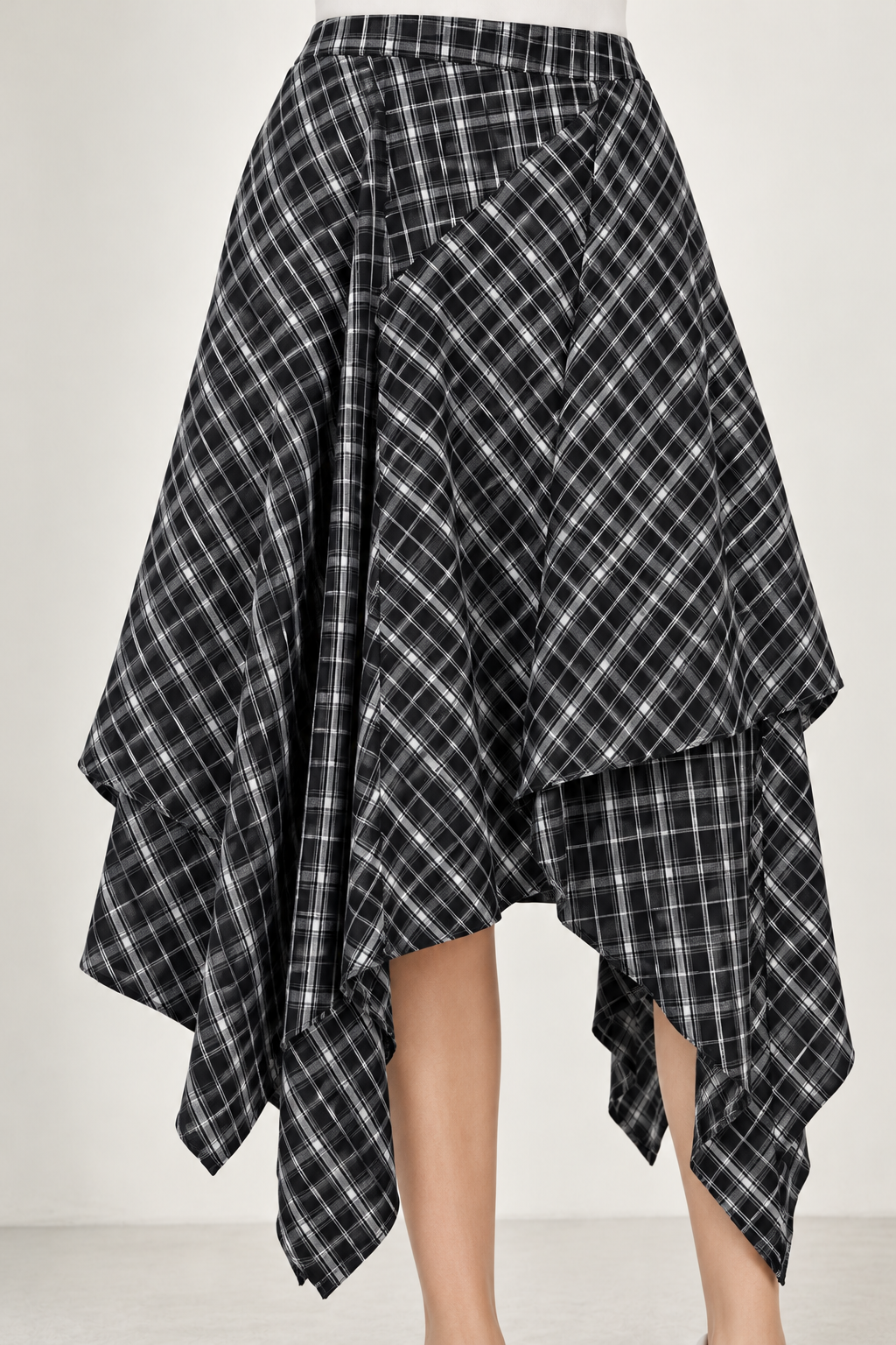 A ruffled skirt with a black and white checkered pattern and a side slit.