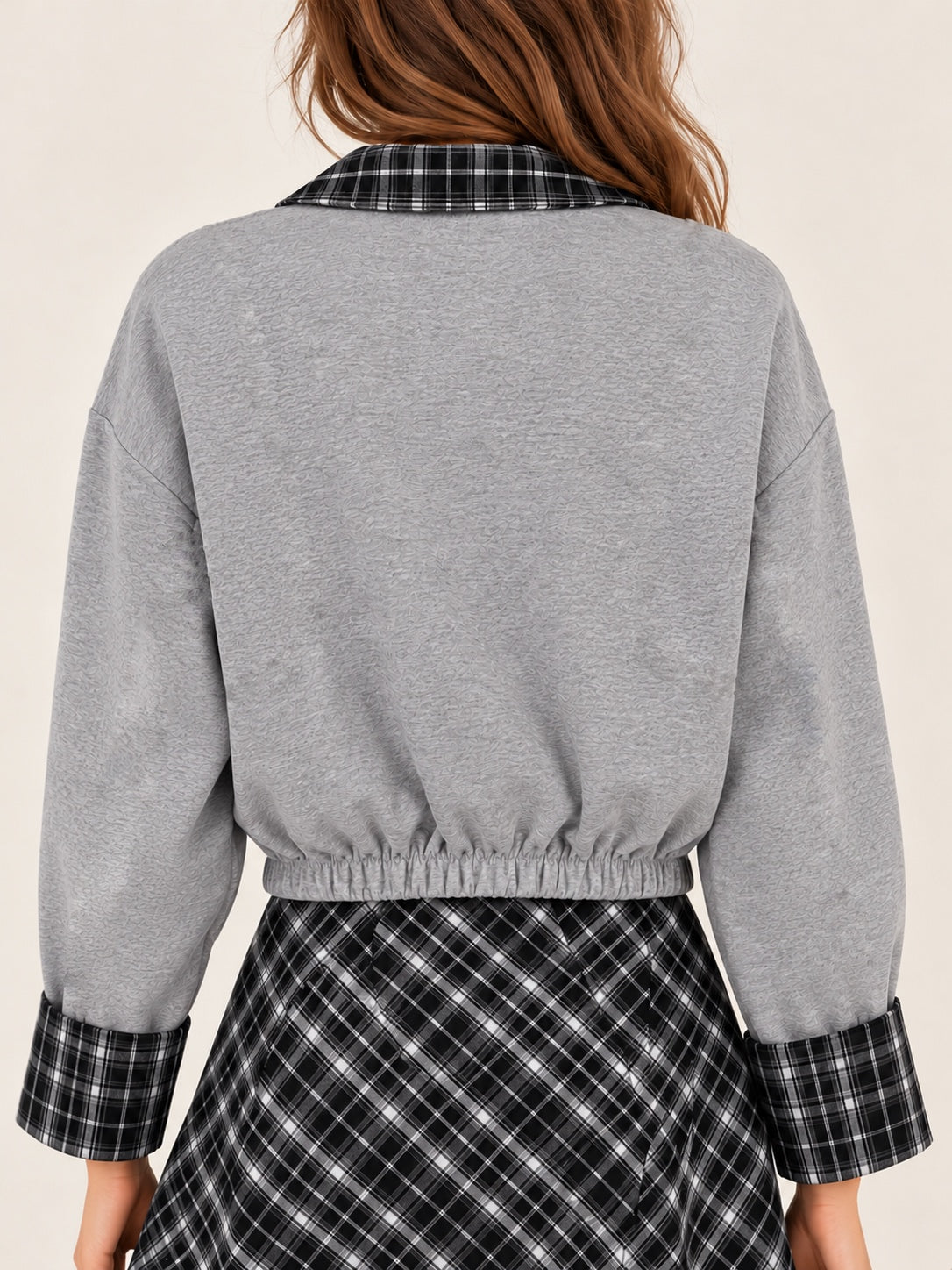 Gray jacket with a collar and sleeves, black and white checkered pattern.