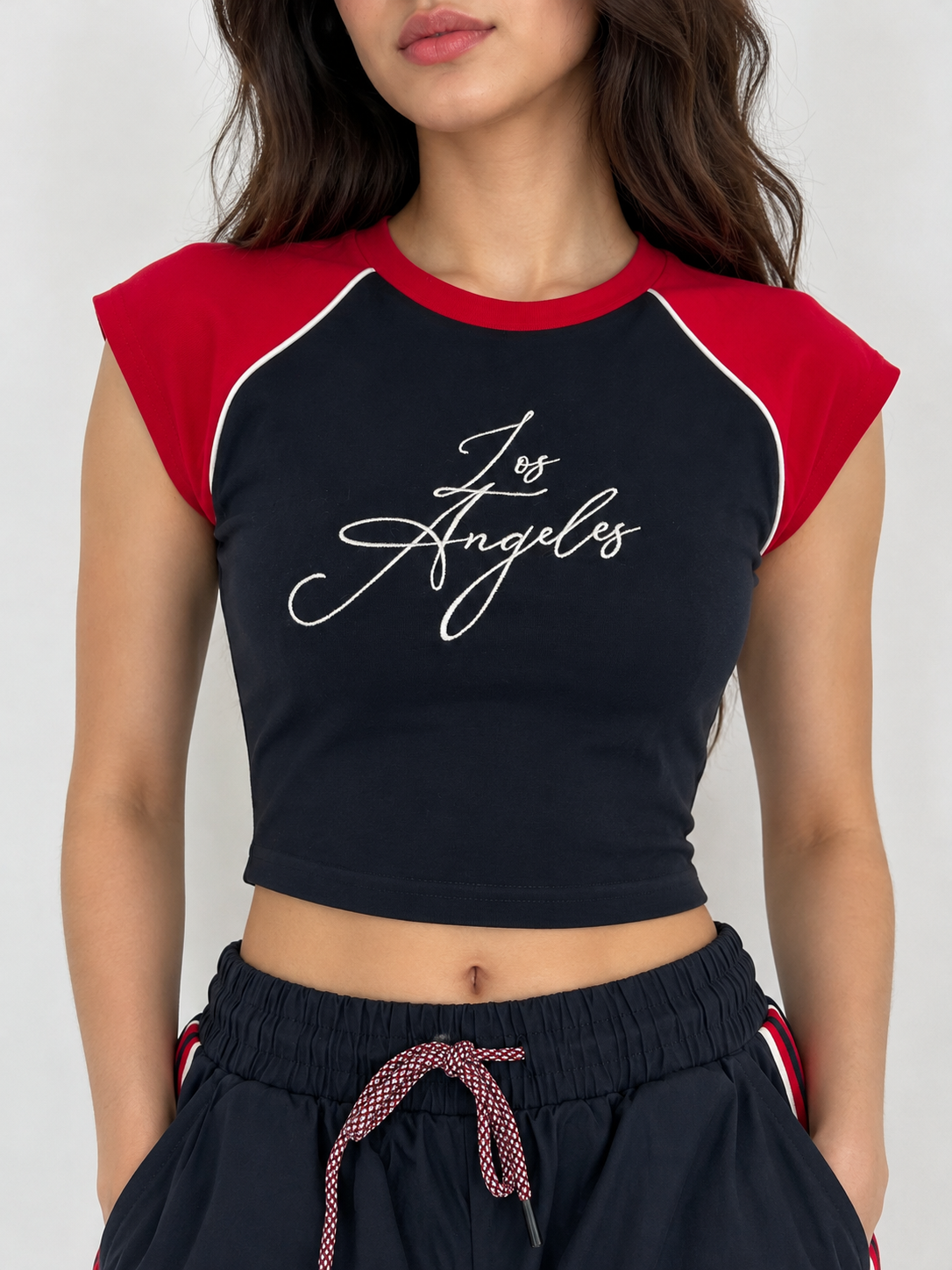 Navy blue t-shirt with red shoulders and the word "LOS ANGELES" on the chest.