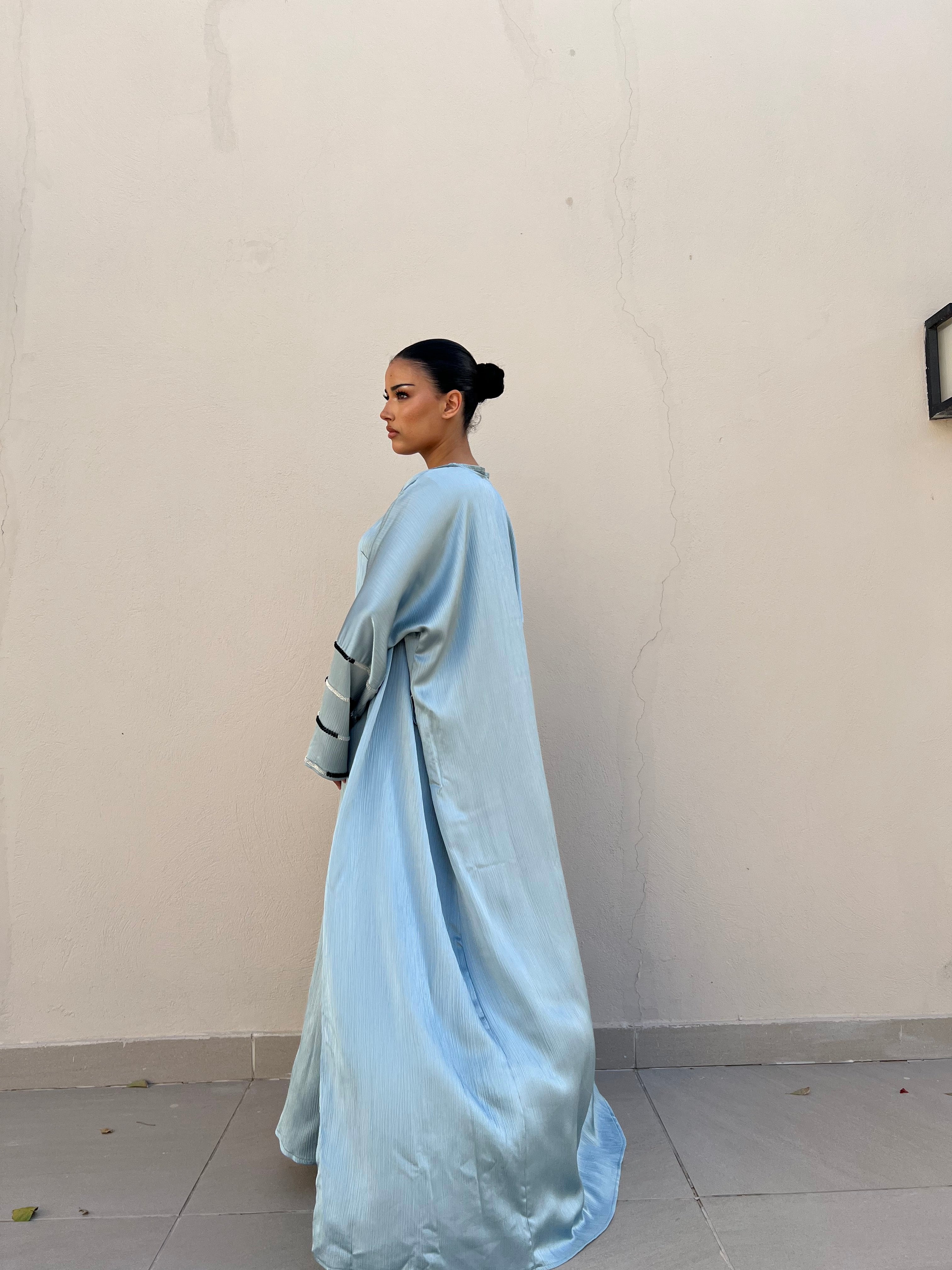 Flowy abaya with beads on the sleeves and a sleeveless dress