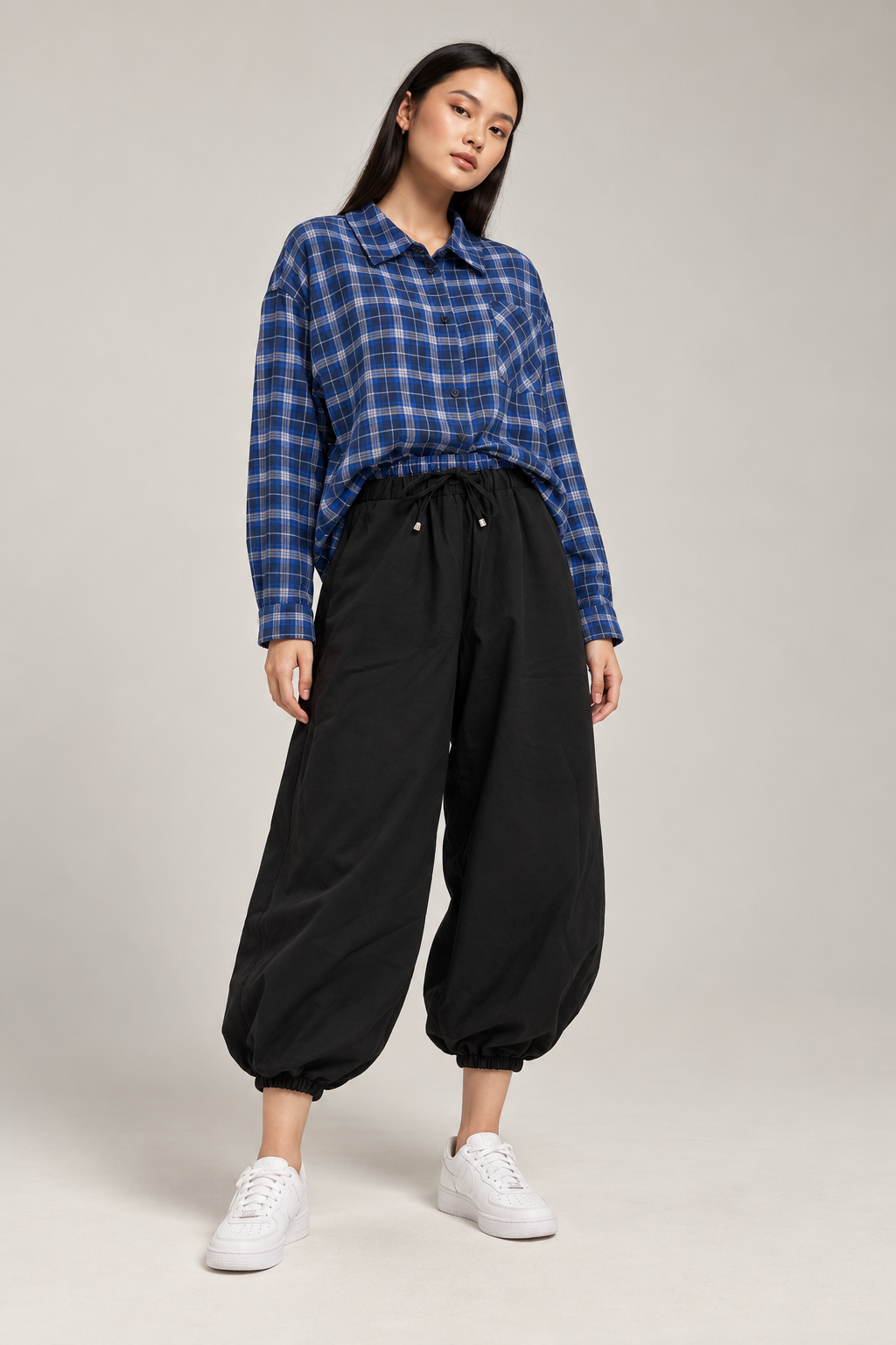 Black balloon pants with a blue checkered waistband and tie