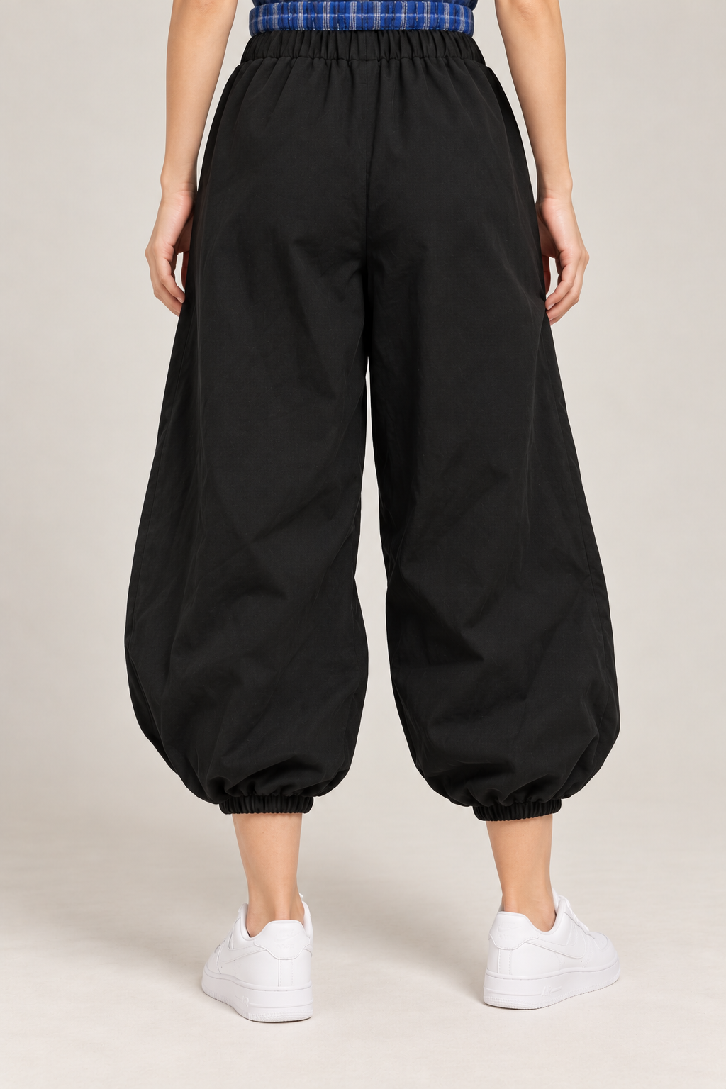 Black balloon pants with a blue checkered waistband and tie