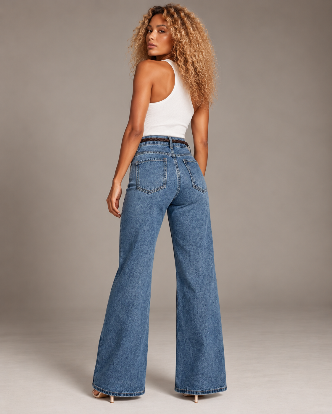 Blue flared jeans with a brown braided belt