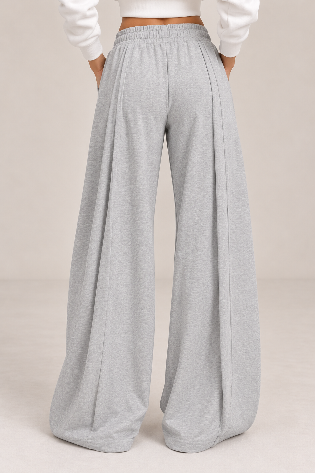 Wide-legged joggers, light gray, with a drawstring waist and pleated waistband.