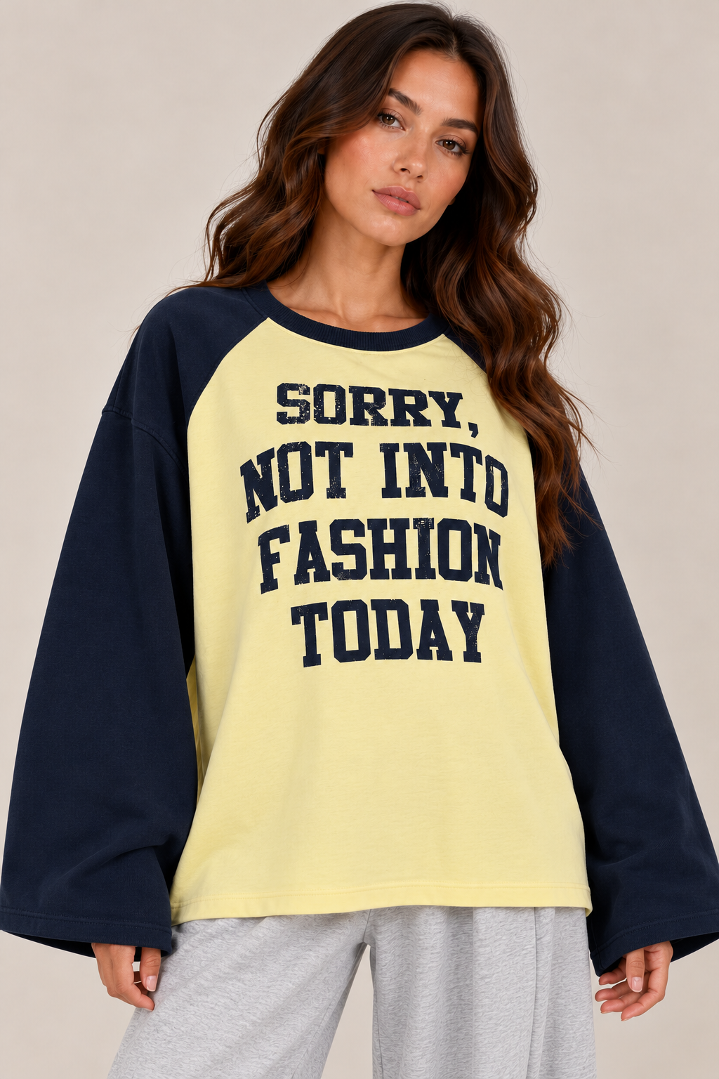 An oversized two-tone blouse featuring the words "Sorry not into fashion today"