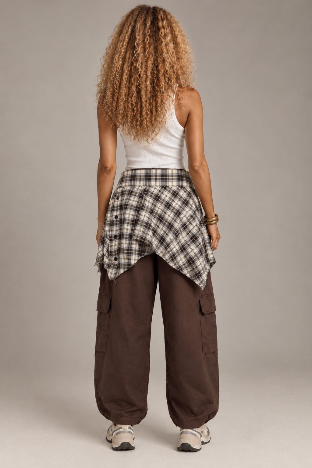 Brown cargo baggy pants with a beige checkered shirt waistband