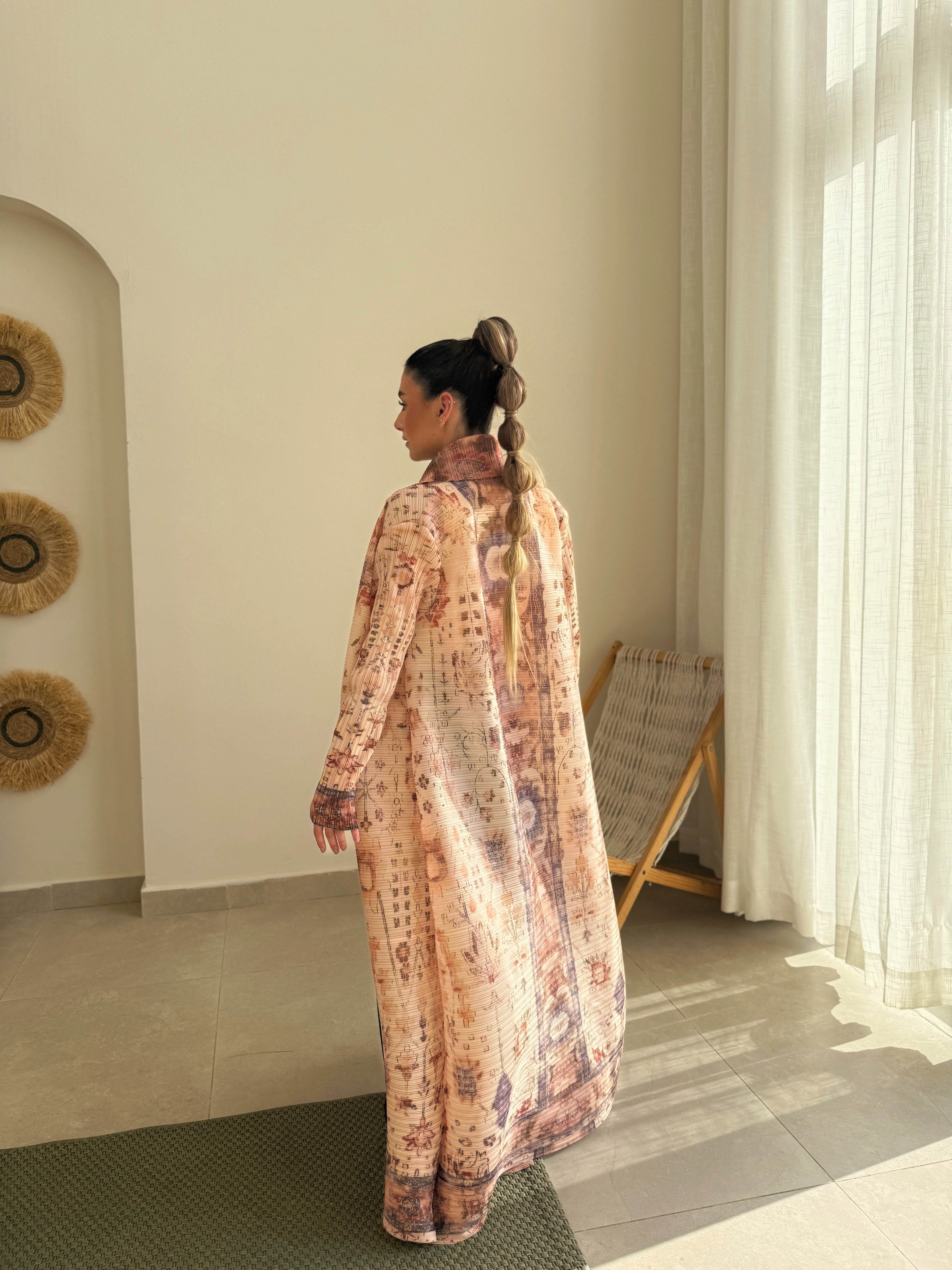Beige and brown patterned abaya with a tied waist
